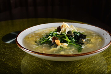 asian premium banquet menu stir fried water spinach vegetables with 3 type of golden eggs in thick gravy sauce on gold background dining table