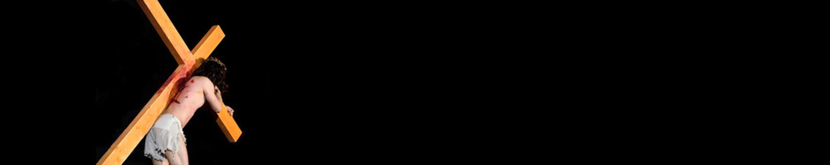 Jesus carrying the Cross into the darkness.