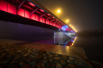 Bridge Śląsko-Dąbrowsk over the river vistula at night with fog and rain, long exposure photo in...