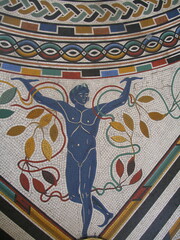 ornate inlaid geometric  patterns and a male figure in  the mosaic tiled floor in the vatican...