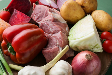 Ingredients for preparing borscht on color background, closeup