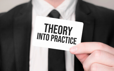 Businessman holding a card with text Theory into Practice