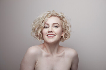 Headshot of gorgeous attractive young lady with curly hair smiling. Marilyn Monroe