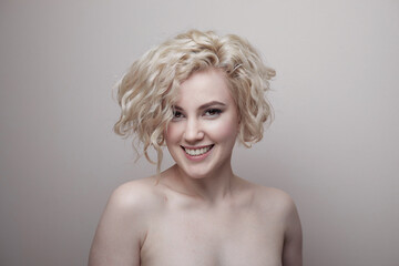 Headshot of gorgeous attractive young lady with curly hair smiling. Marilyn Monroe