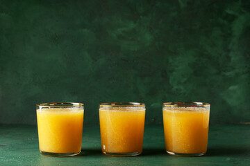 Glasses of tasty pineapple smoothie on color background
