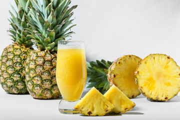 Fototapeta na wymiar Glass of tasty pineapple smoothie on white background