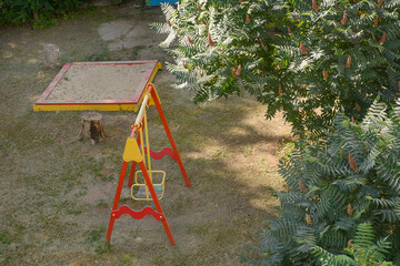 Swing and sandbox for children on playground. View from above