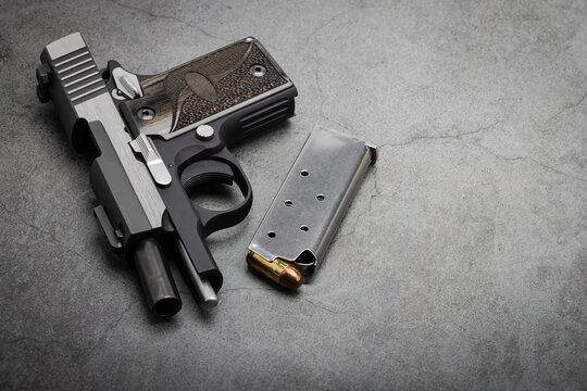 Semi Automatic Pistol Hand Gun With Bullet Magazine On Texture Background , Back Up Gun