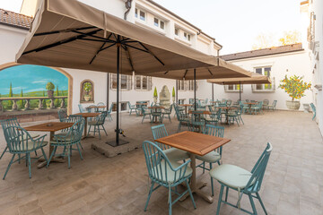 Empty terrace hotel restaurant with sun shades