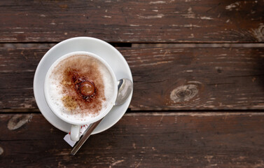 cup of coffee on woodenn table topview from top view
