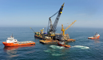 formation of workboats surrounding an offshore construction and transportation to build a new...