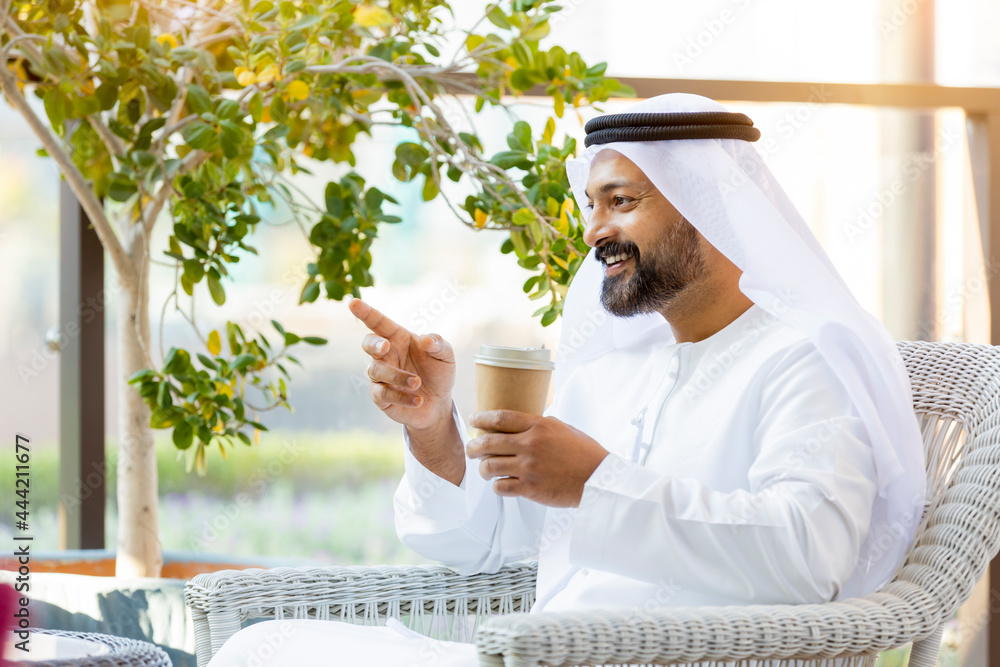 Wall mural middle eastern arab emirati man at the cafe in dubai, united arab emirates