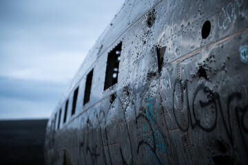 Close-up of fuselage of crashed aircraft at Solheimasandur in Iceland on a sad dark rainy day