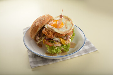 chef handmade giant deep fried crispy chicken with fried egg and vegetables cheesy burger in japanese sesame sauce western fast food halal menu