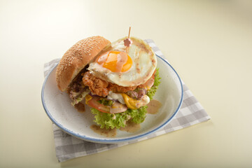 chef handmade giant deep fried crispy chicken with fried egg and vegetables cheesy burger in japanese sesame sauce western fast food halal menu