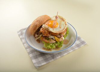 chef handmade giant deep fried crispy chicken with fried egg and vegetables cheesy burger in japanese sesame sauce western fast food halal menu