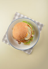 chef handmade giant deep fried crispy chicken with fried egg and vegetables cheesy burger in japanese sesame sauce western fast food halal menu