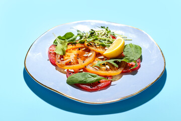 Plate with tasty tomato carpaccio on color background