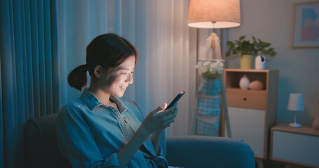 woman using phone at night