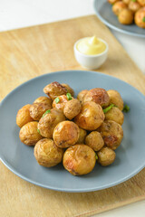 Plate with tasty baked potato on table