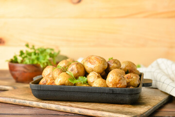 Dish with tasty baked potato on table