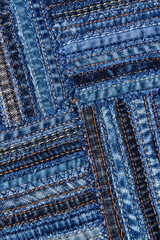 Diagonal denim fabric pattern in patchwork style.