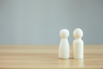 person male and female model icon on wood background, copy space.