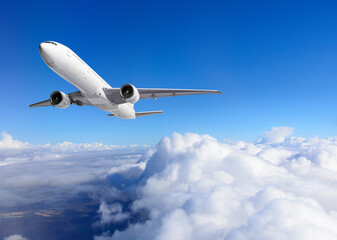 Fototapeta na wymiar Airplane flying above clouds on blue sky background