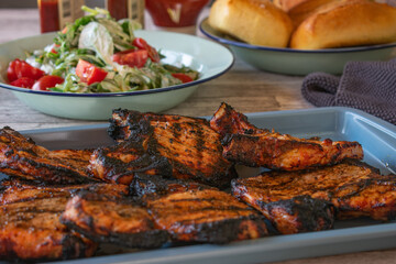 grilled pork chops with salad and buns