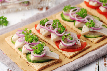 Sandwiches with herring and vegetables