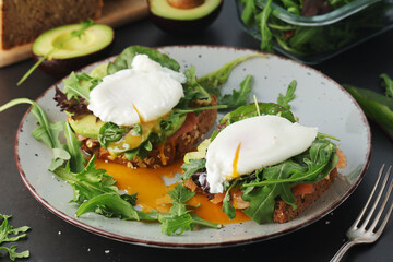 Homemade sandwiches with salmon, avocado and poached eggs