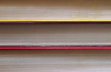 Three books in a stack. Pages and covers