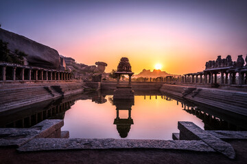 Fototapeta premium View of sunrise at Pushkarni, Sri Krishna tank in ruins. Hampi, karnataka, India.