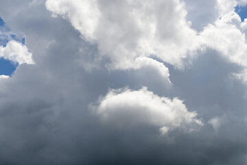 Sky background with grey cloud formation and sunshine