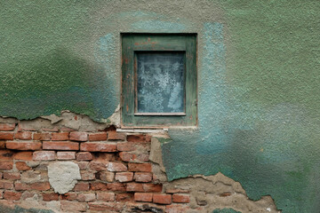 old green soaked brick wall wooden window