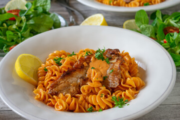 Pasta with fish and creamy tomato sauce