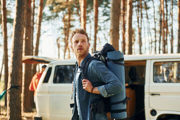 Man is traveling alone in the forest at daytime at summer