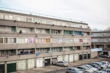 A concrete council block with communal parking space in south east London