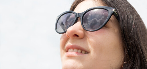 Beautiful brunette woman smiling in sunglasses with place for text. Glasses advertising,...