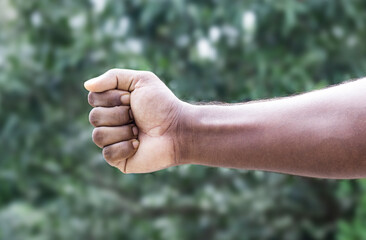 Men strong fist hand stretching toward close up