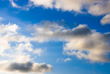 Shiny dramatic blue sky with white clouds