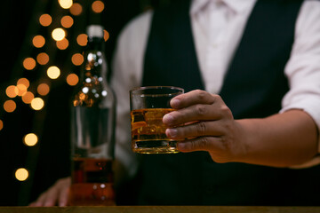 Barman pouring whiskey whiskey glass beautiful night celebrate whiskey on a friendly party in  restaurant