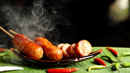Hot sausage on a dark background with bokeh