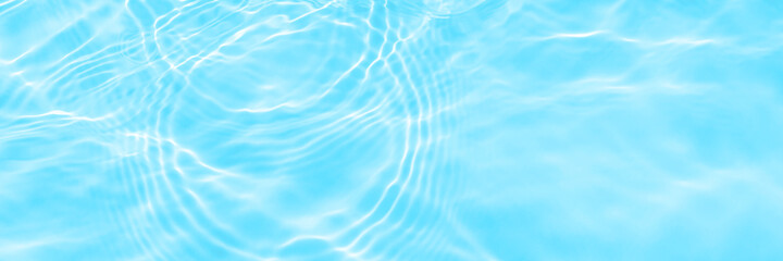 Surface of lights on blue transparent swimming pool water texture. Trendy abstract wavy background. Water waves in sunlight with copy space. Long banner.