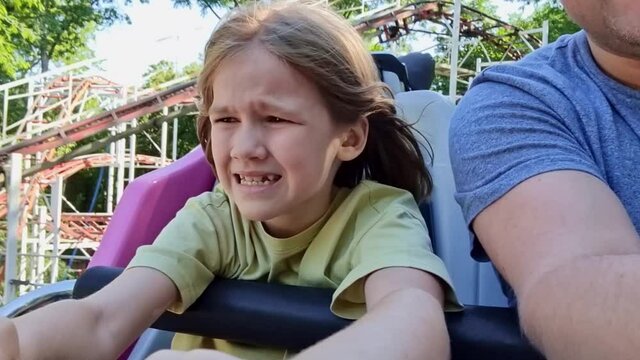dad and daughter ride extreme attraction. adrenaline and fun in amusement park