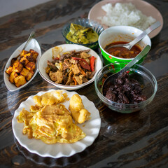 Assorted Malay dishes served on the table. Staple menu for lunch and dinner in Malaysia.