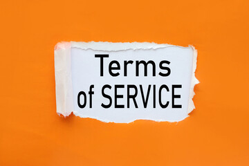 Term Of Service. text on torn paper. test in black letters