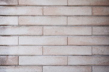 Empty background of rusty white pink brick wall texture. Close up of old grungy brick tile wall surface as design backdrop.
