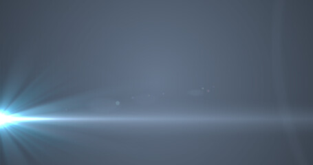 Glowing blue rays of light moving against grey background