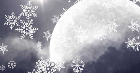 Obraz premium Snow particles falling against moon in night sky